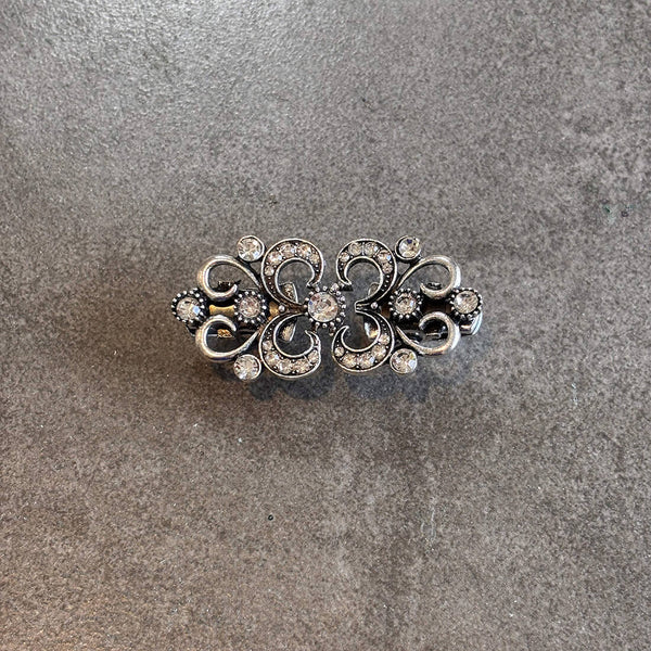 silver clothing cinch styling tool