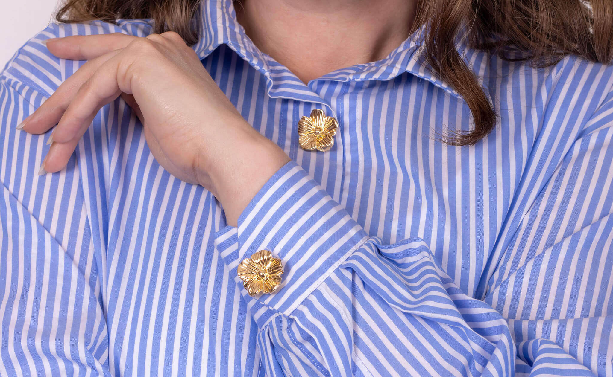 Womens striped shirt and gold flower button covers