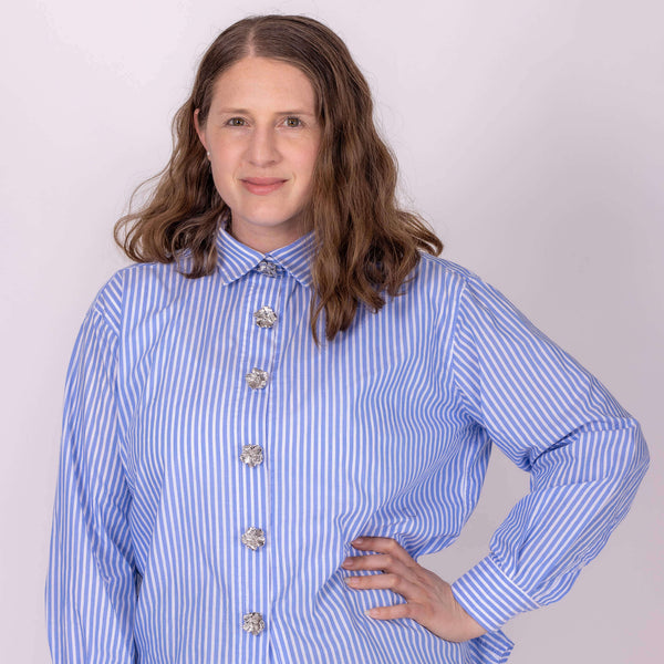 woman wearing shirt with silver flower button covers